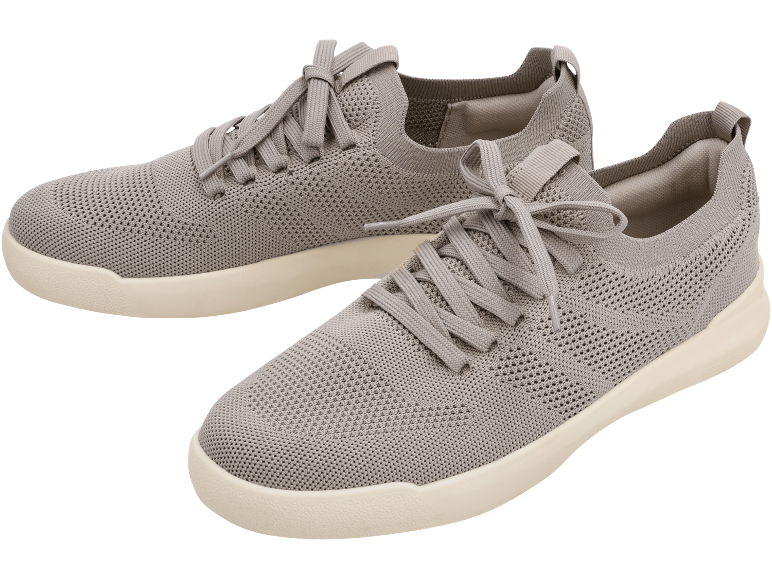 Pair of grey knitted sports shoes with white soles.