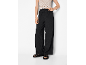 Black wide-leg trousers with a cream crochet top and black sandals.