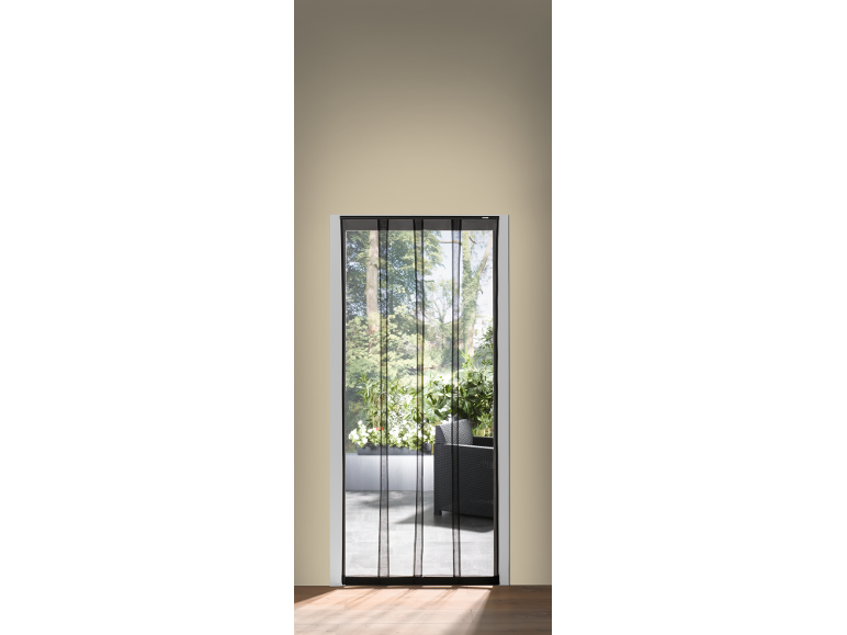 Black mosquito net on a door leading to a balcony with plants and furniture.
