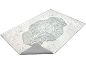 Rug with classic medallion design in cream and mint green tones, with visible anti-slip backing.