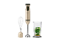 Gold 600W immersion blender with whisk attachment and measuring cup with greens.