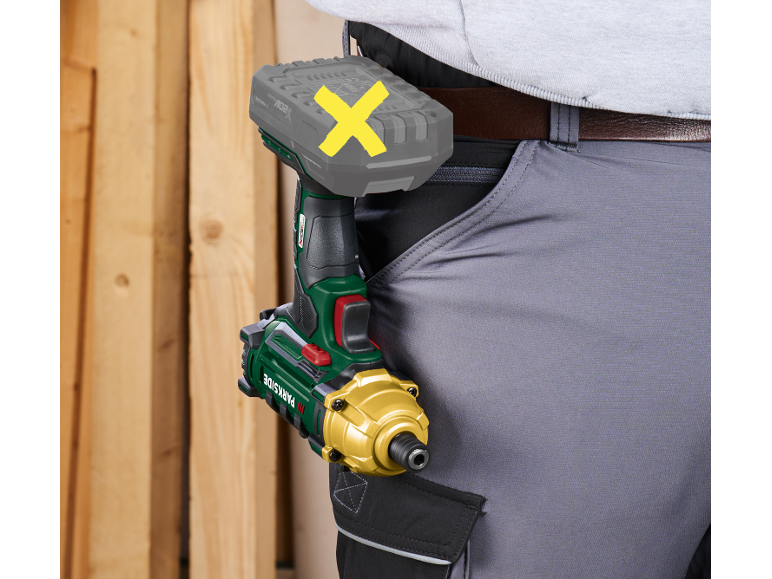 Person wearing work trousers with an impact driver and battery pack attached to their belt.