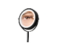 Illuminated makeup mirror reflecting an eye applying eyeshadow.