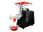 Meat grinder with tomatoes in the tray and tomato sauce in a bowl.