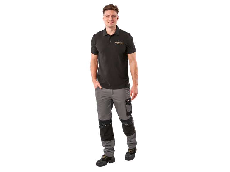 Man in black polo shirt with logo and grey work trousers.