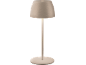 Beige table lamp with a round base and an illuminated dome-shaped head.