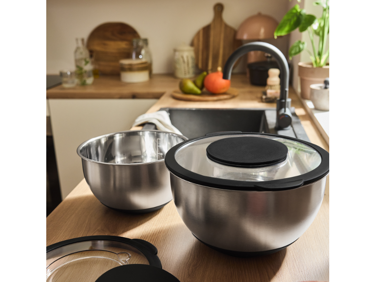 Kitchen counter with two stainless steel bowls, one with a closed lid.