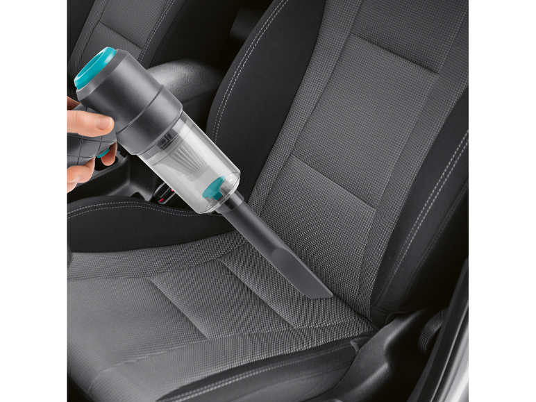 Cordless handheld vacuum cleaner cleaning a car interior.