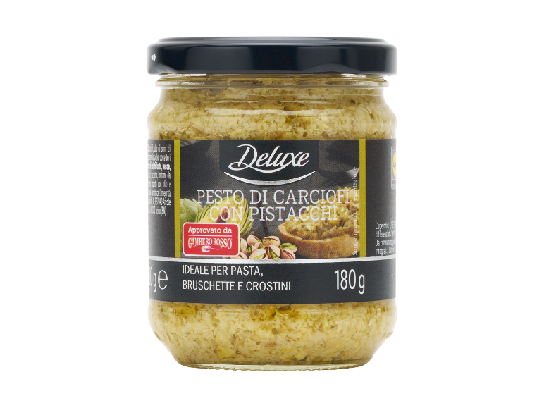 Artichoke pesto with pistachios in a glass jar, ideal for pasta, bruschetta, and crostini.