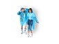 Two people wearing blue disposable rain ponchos, one with a patterned design.