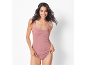 Woman in pink lace-trimmed camisole and briefs.
