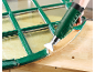 Heat gun removing paint from an old window frame.