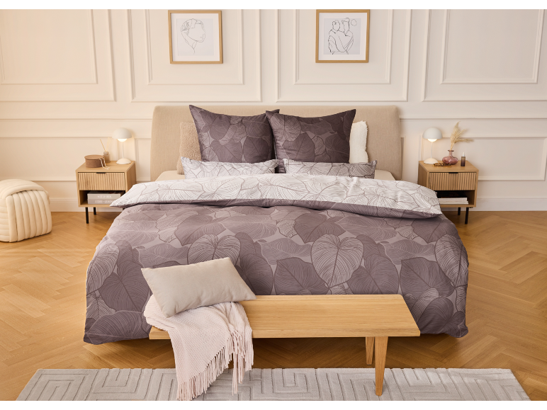 Bedroom with a grey leaf-patterned duvet cover set and a wooden headboard.
