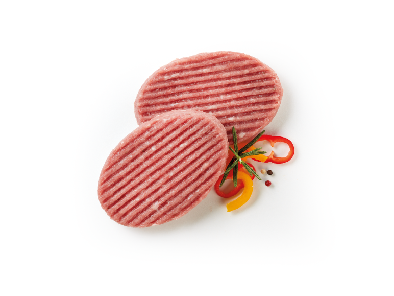 Two raw burger patties with rosemary and sliced peppers.