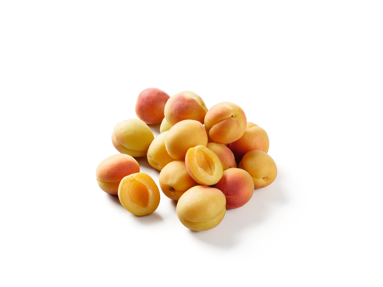 A pile of fresh apricots, some whole and some cut in half, on a white background.