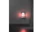 Red night light plugged into a wall above the floor.