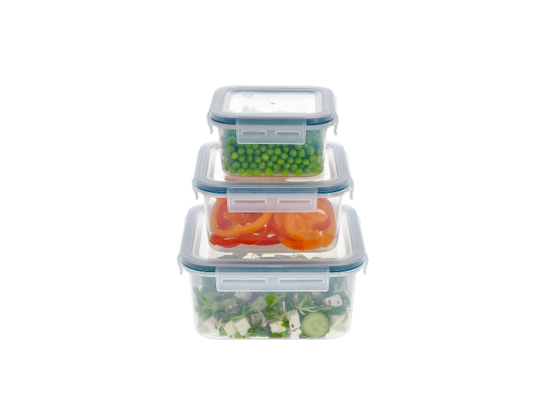 Stackable food containers with peas, bell peppers, and fresh salad.