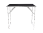 Foldable workbench with a black surface and a silver aluminum frame.