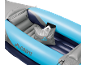 Inflatable kayak with seats and a waterproof bag holding a tablet.