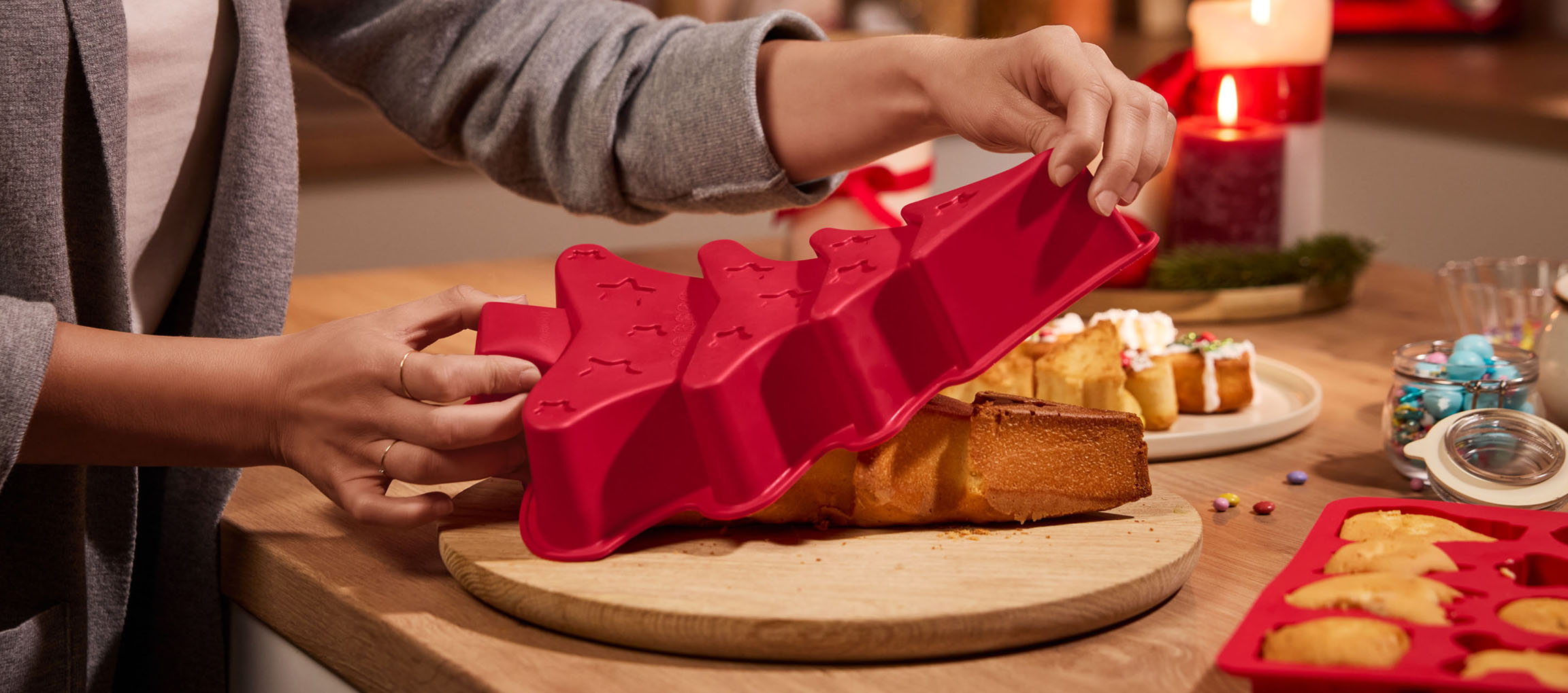 Unmolding a Christmas tree cake from a red silicone mold.