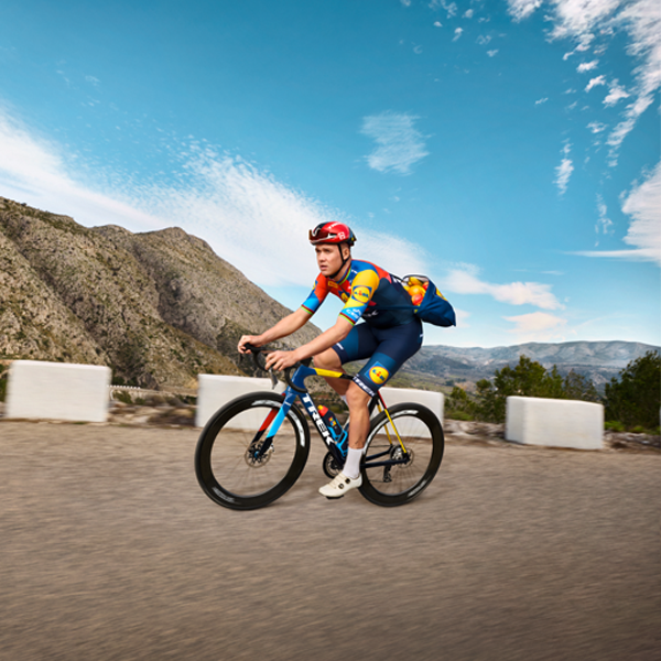 Cyclist on a Trek bike in hilly terrain.