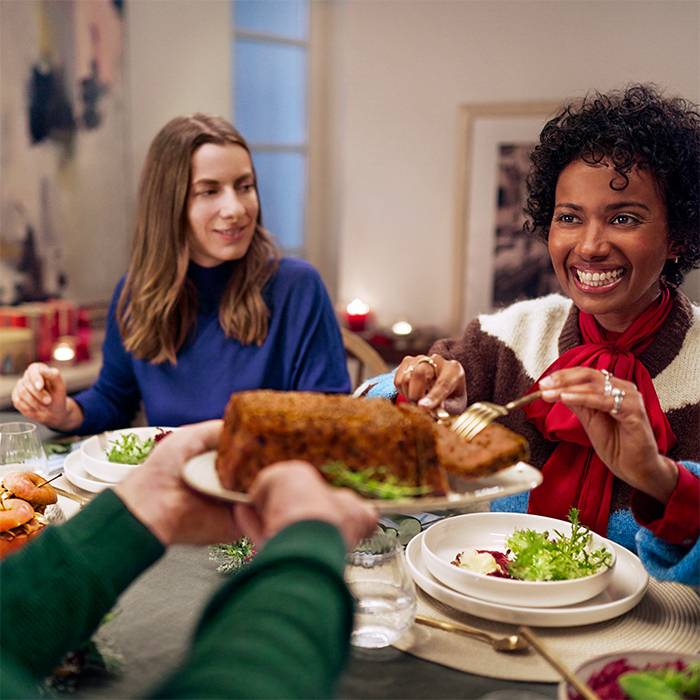 People sharing a meal at a festive table.