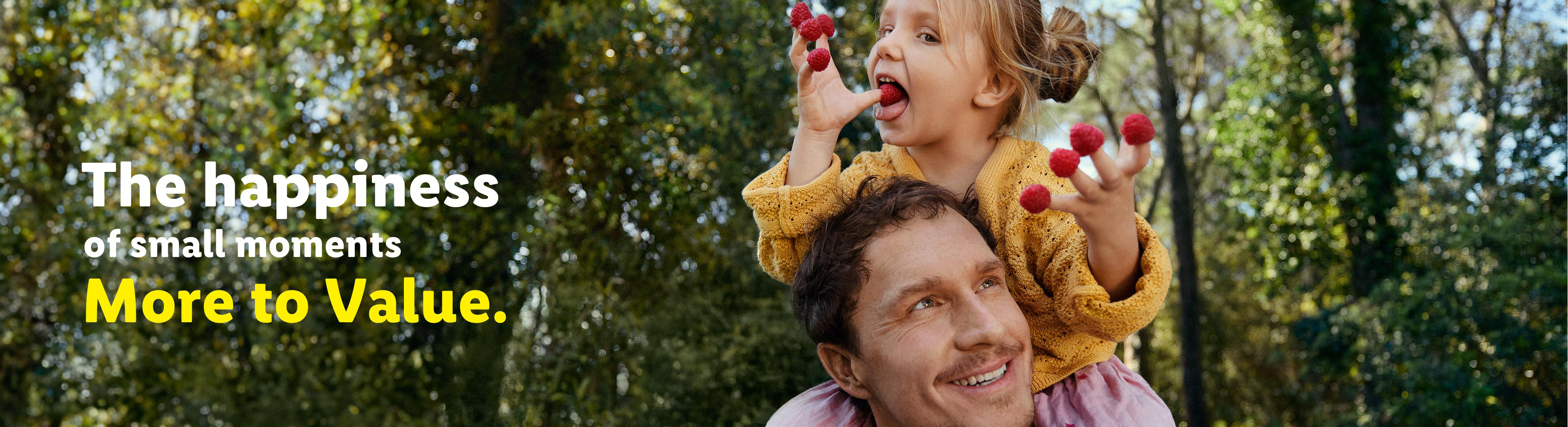 A father carries his daughter on his shoulders, who is eating raspberries, with text about happiness.