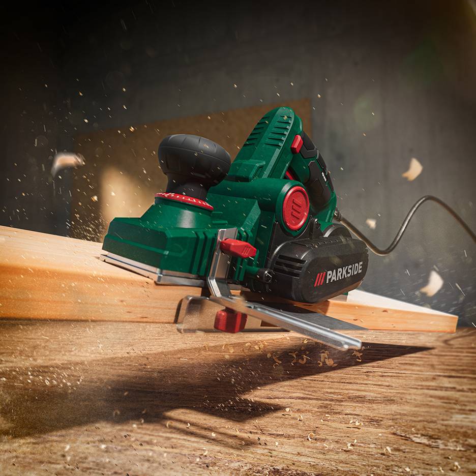 Parkside electric planer in action, creating wood shavings.