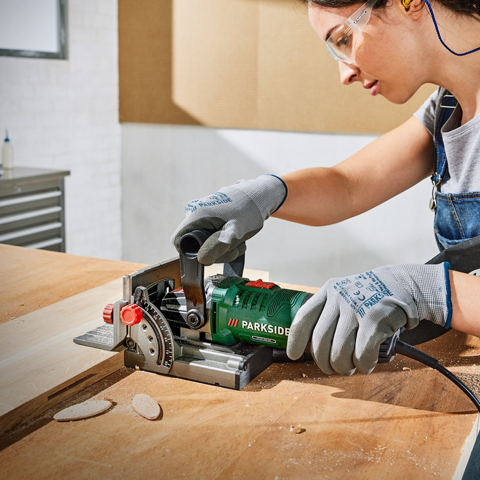A woman uses a Parkside woodworking tool.