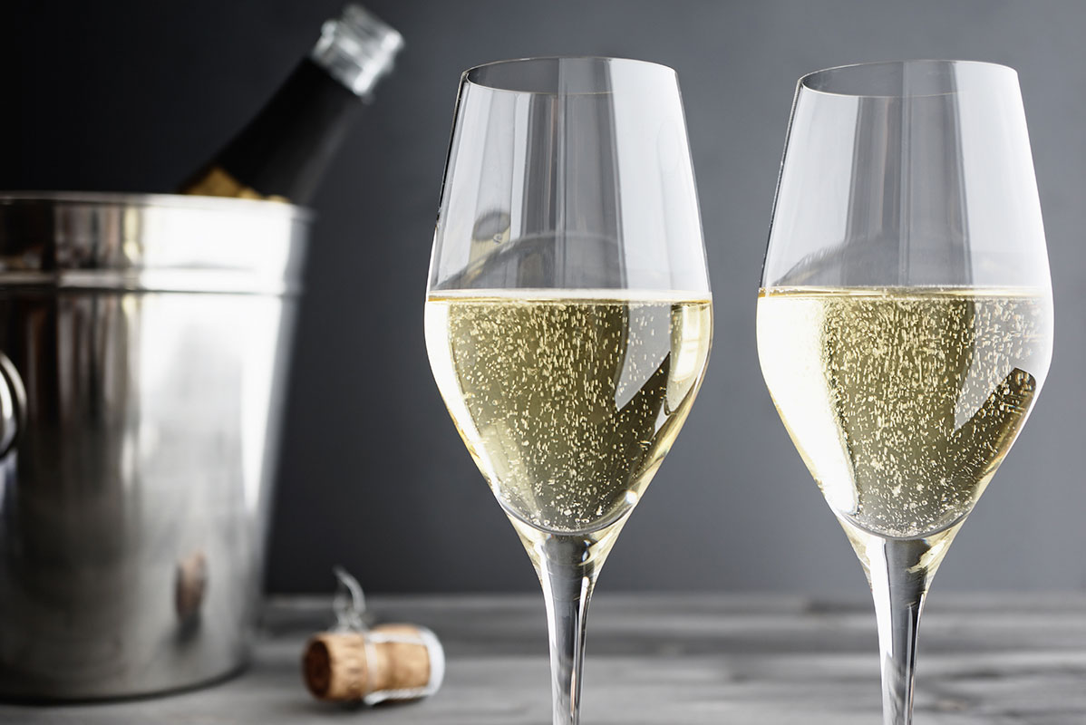Two champagne flutes and a chilled bottle.