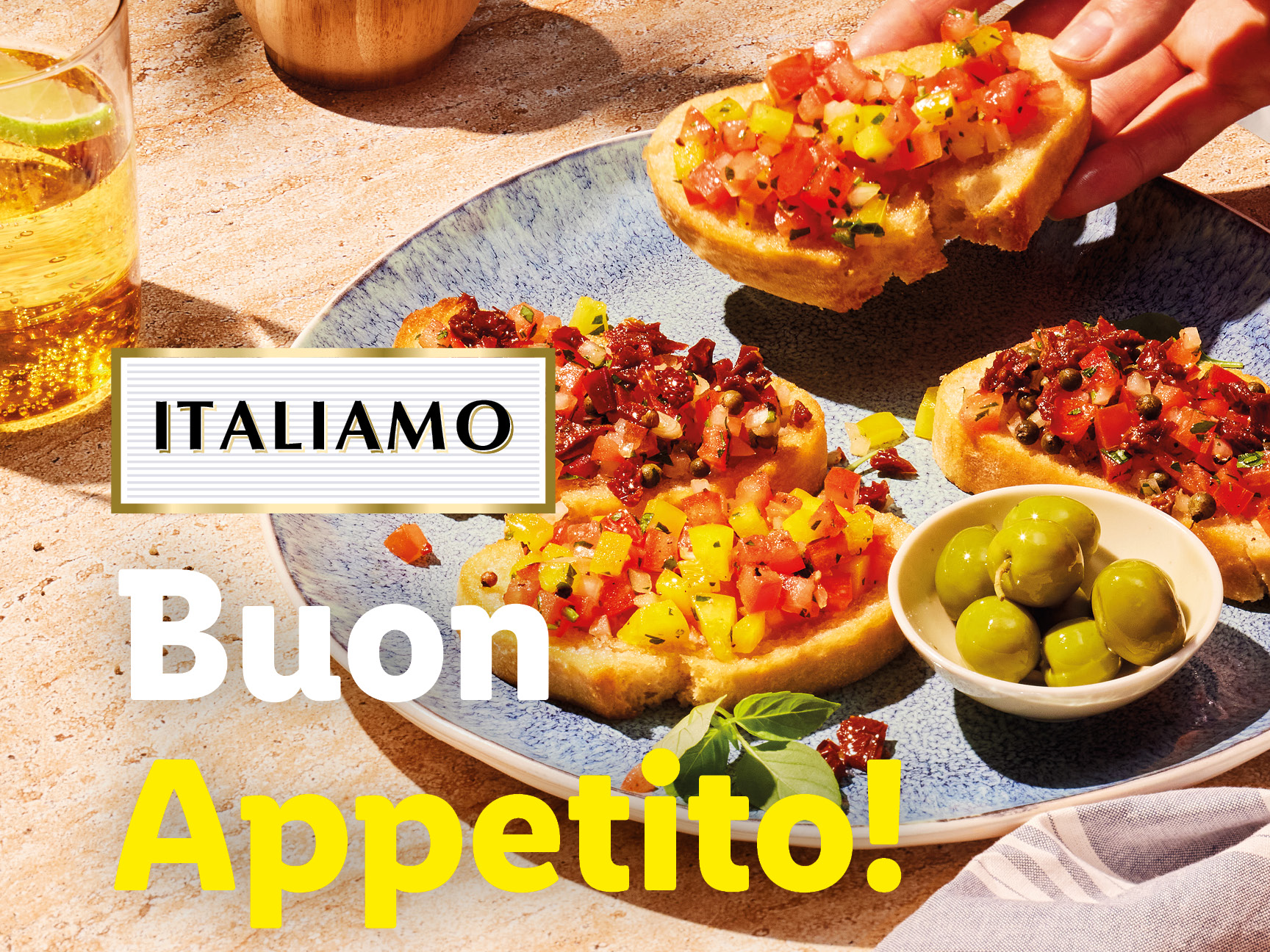 A plate of bruschetta with tomatoes and olives, with text 'ITALIAMO Buon Appetito!'