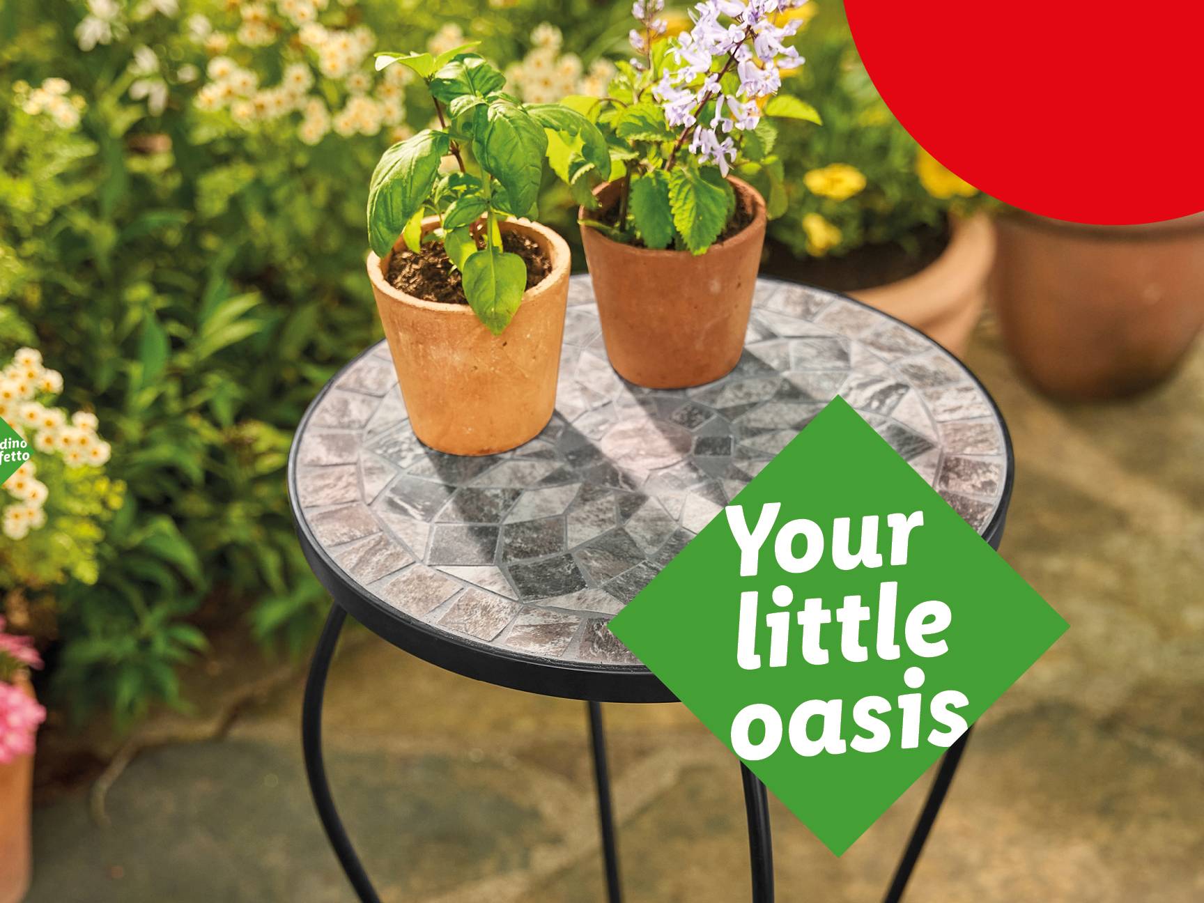 Two potted plants on a mosaic table with a green sign saying 'Your little oasis'.