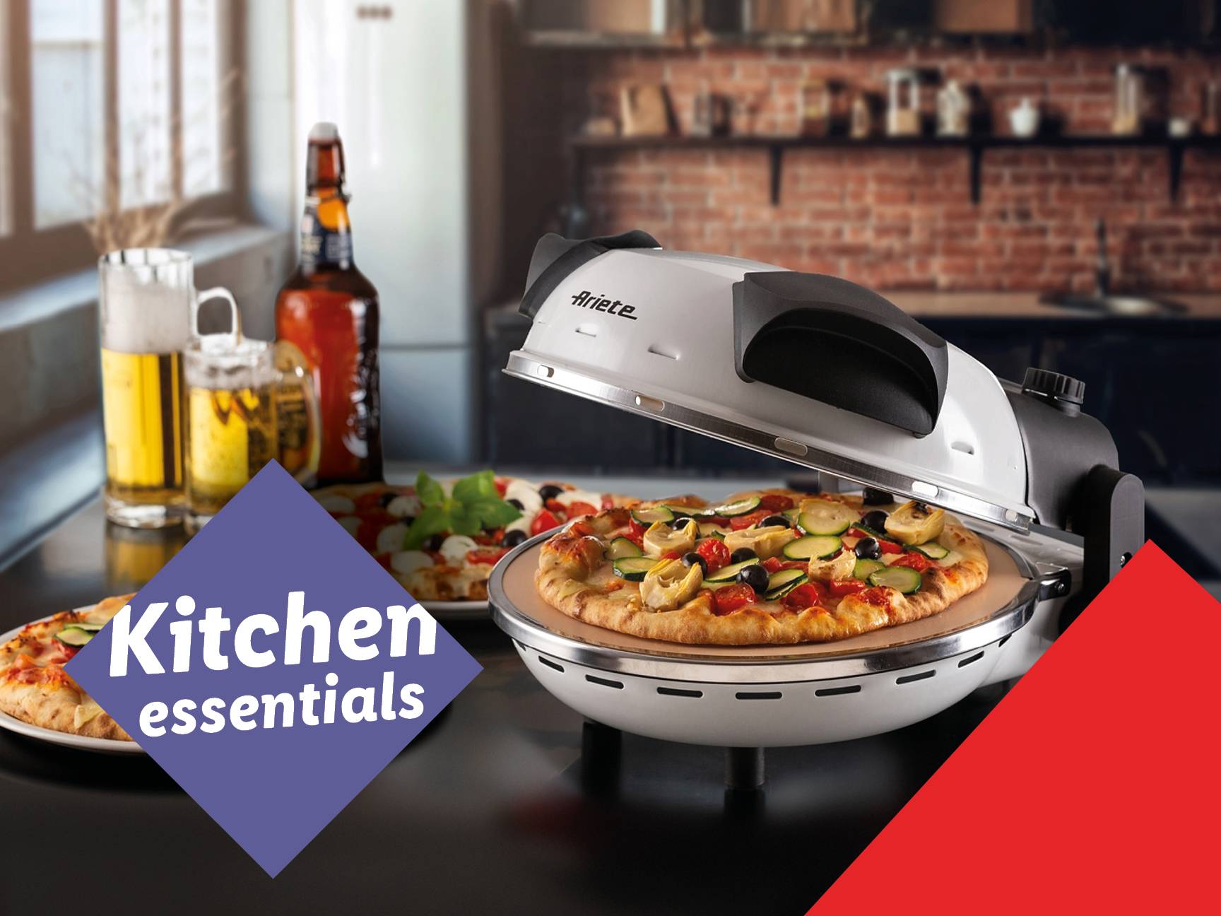 Ariete pizza oven with a pizza inside, beer, and other pizzas on a kitchen counter.