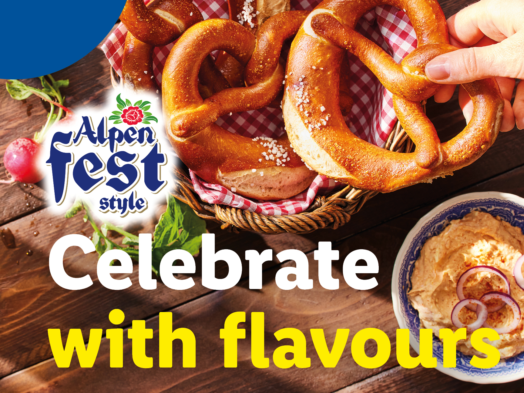 Pretzels in a basket with a hand reaching for one, next to a dip and radishes.