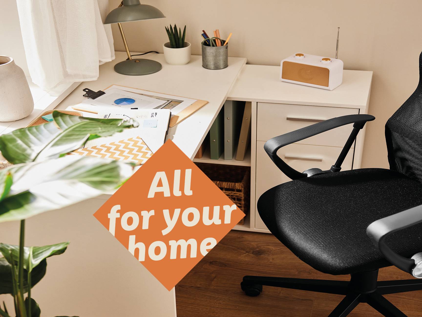 A home office setup with a desk, office chair, lamp, and various office supplies.