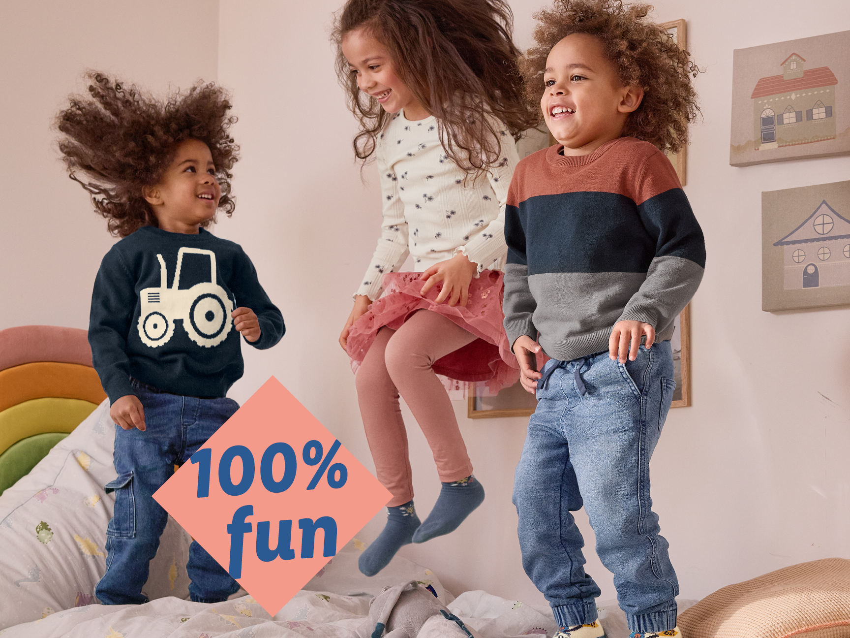 Three happy children in casual clothes jumping on a bed, with a '100% fun' graphic.