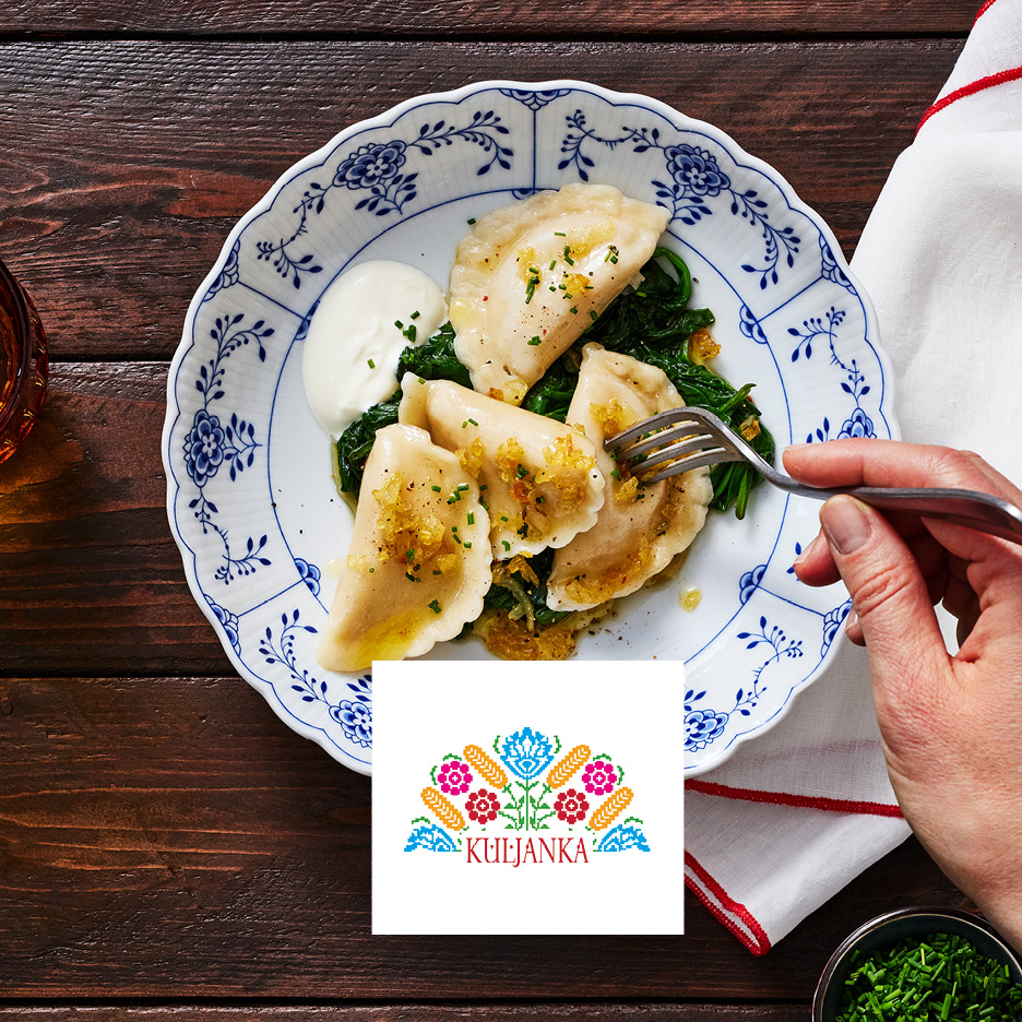 Pierogi with spinach, sour cream, fried onions, and a 'KULJANKA' logo.