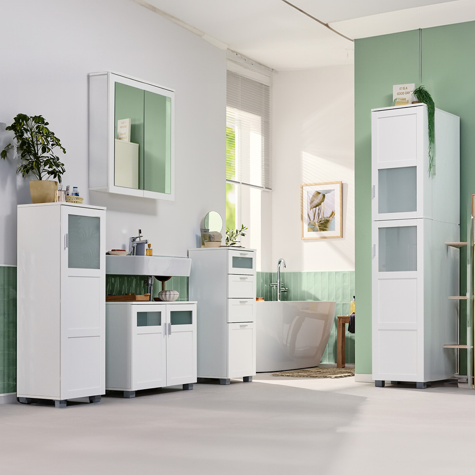 White bathroom furniture set with cabinets, sink, mirror, and bathtub in a modern bathroom.