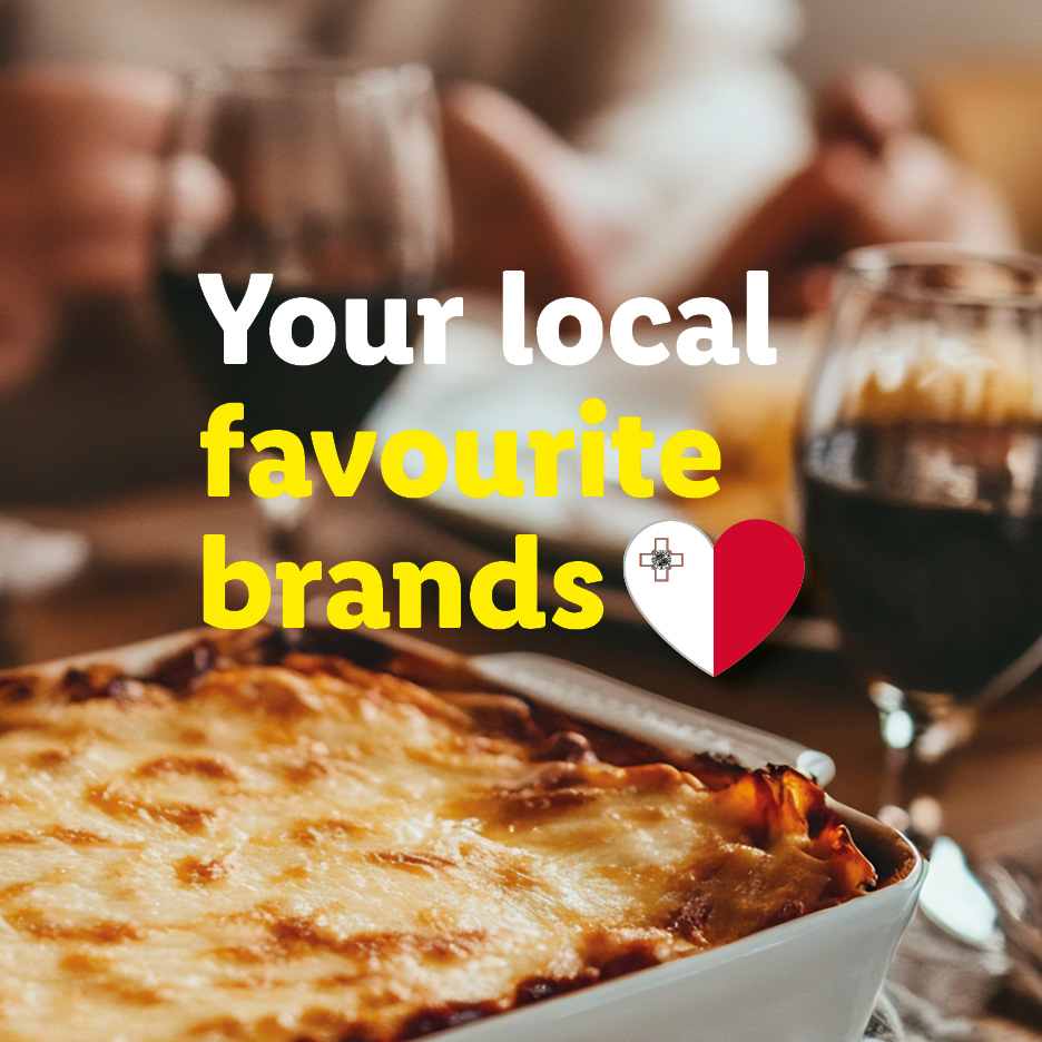 Lasagna and wine on a table with text 'Your local favourite brands' and a Maltese flag heart.