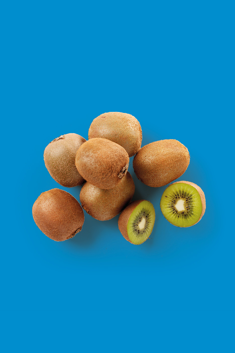 A pile of whole kiwis and two halves of a kiwi on a blue background.