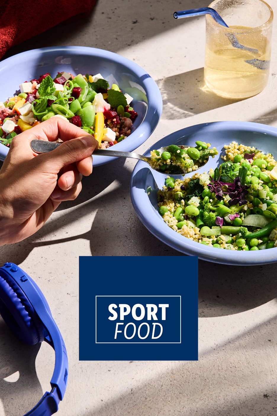 Two bowls of healthy salads, a glass of water, and headphones with 'SPORT FOOD' text.