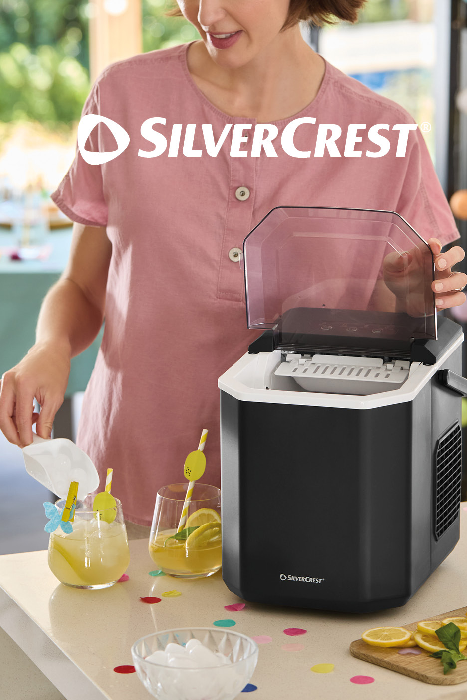 Woman scooping ice from an ice maker into a glass of lemonade on a confetti-strewn table.