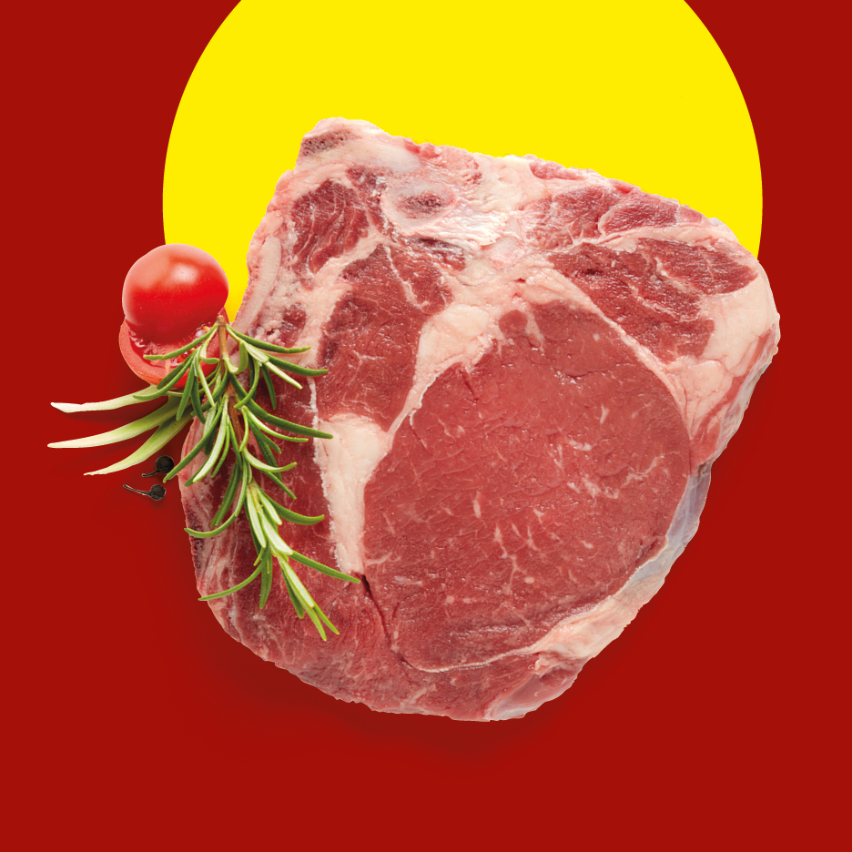 Raw beef steak with rosemary and tomato on a red and yellow background.