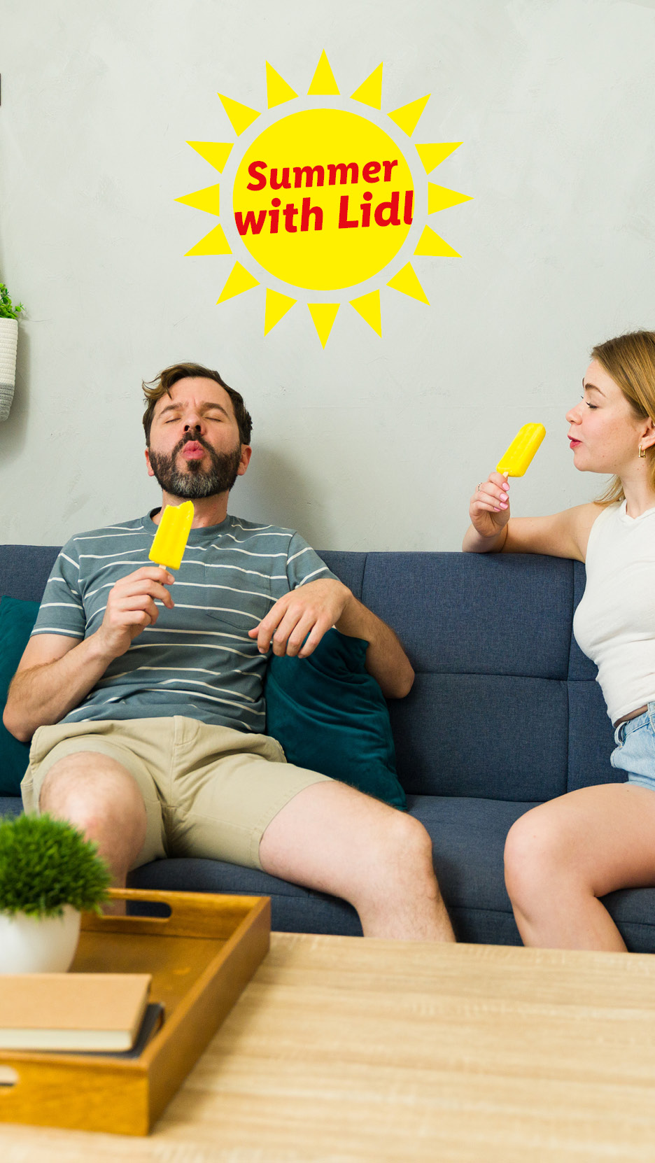 Couple enjoying yellow popsicles on a sofa, with a 'Summer with Lidl' sun graphic.