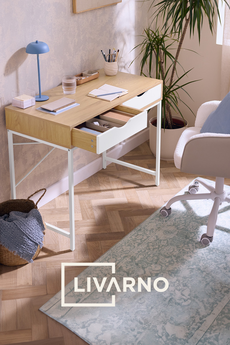 Wooden desk with white drawers, blue lamp, and office chair on a patterned rug.