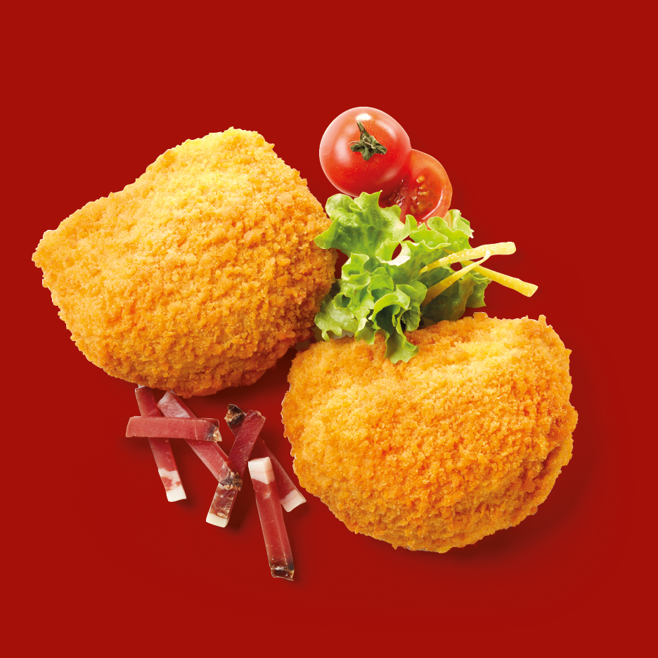 Two golden-brown croquettes with a garnish of lettuce, cherry tomatoes, and prosciutto.