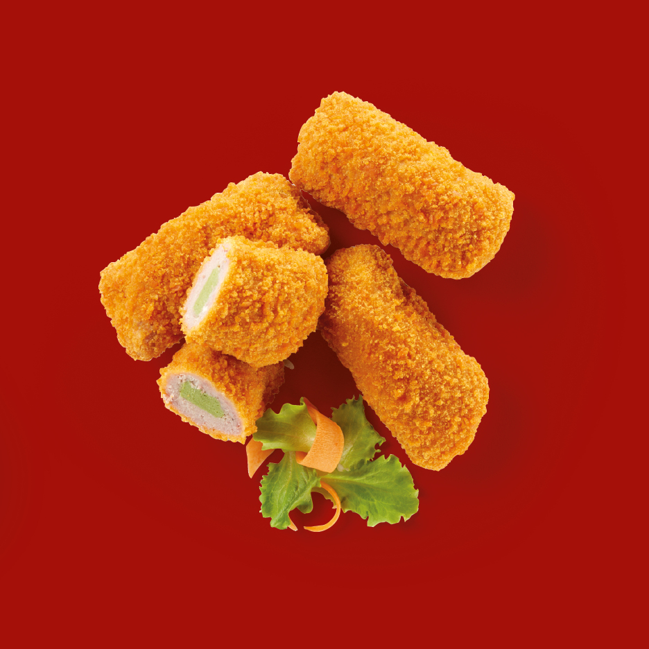 Crispy breaded chicken fingers or nuggets with a green filling, garnished with lettuce and carrot curls.