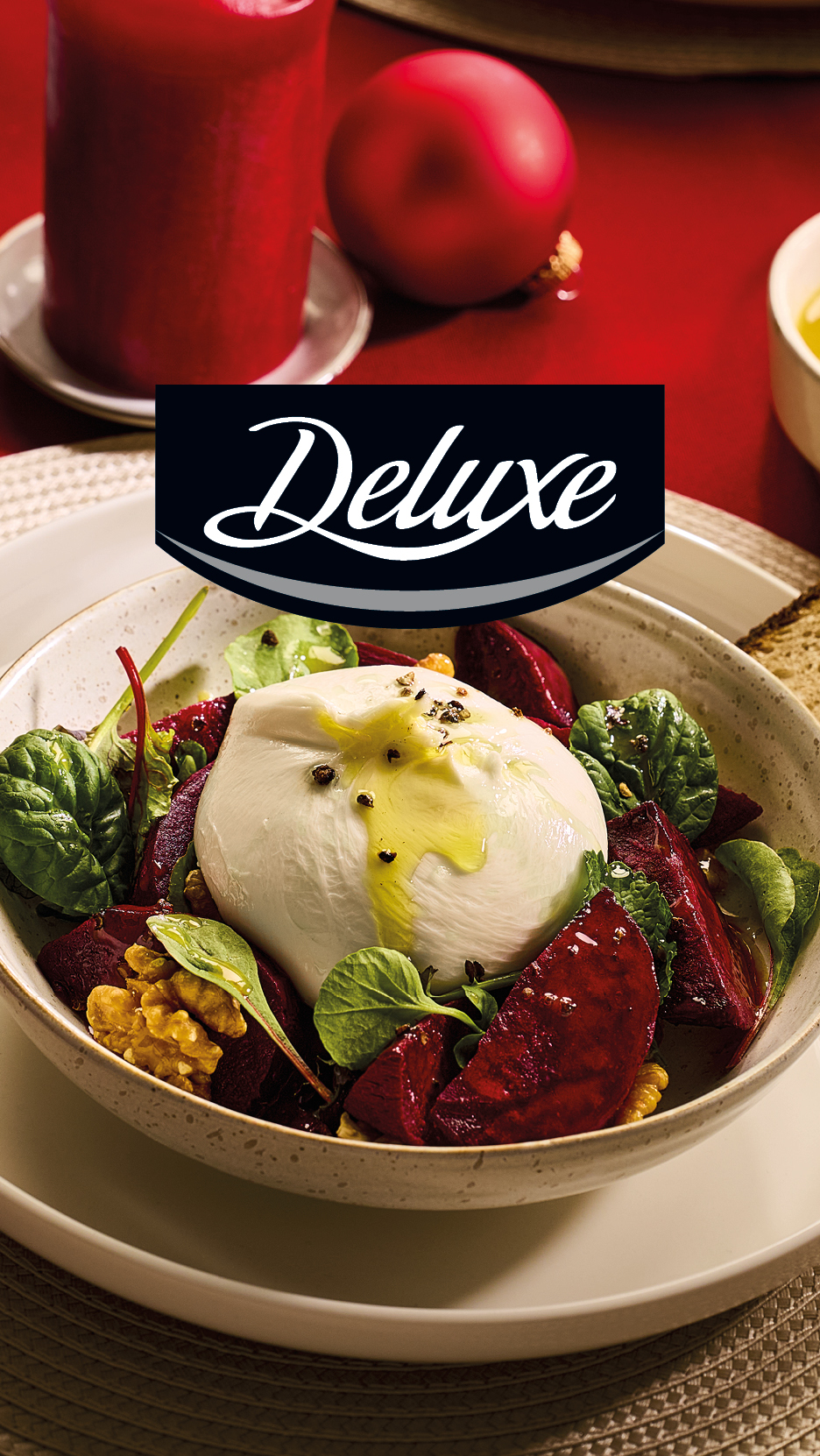 Deluxe burrata salad with beetroot, walnuts, and greens, on a festive table setting.