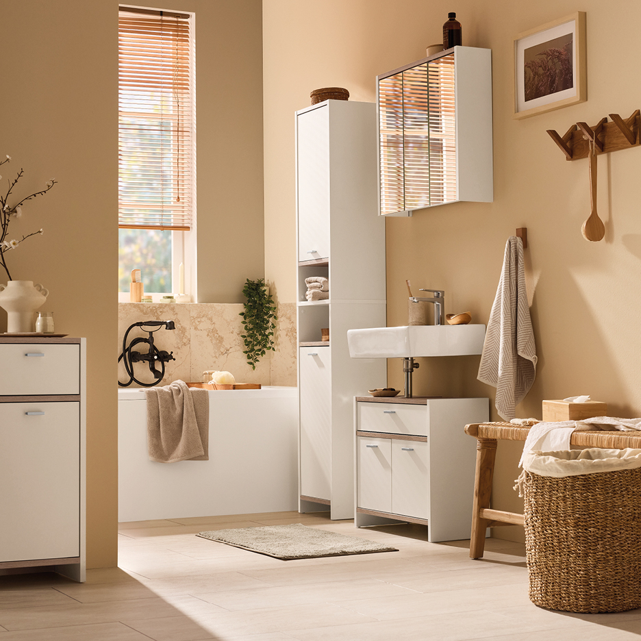 Modern bathroom with white cabinets, a bathtub, and a sink, featuring wooden accents.