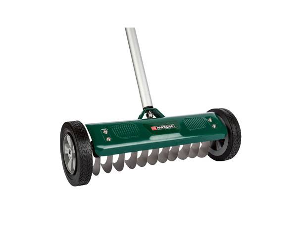 Green manual lawn aerator with wheels and a long handle